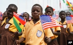 Children waves American and Ghana flags during an arrival ceremony for First lady Melania Trump at Kotoka International Airport in Accra, Ghana, Oct. 2, 2018.