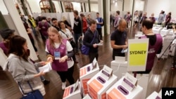 Voters cast their ballots at the Town Hall in Sydney, Australia, in a federal election, May 18, 2019. Polling stations have opened in eastern Australia on Saturday in elections that are likely to deliver the nation's sixth prime minister in as many years.