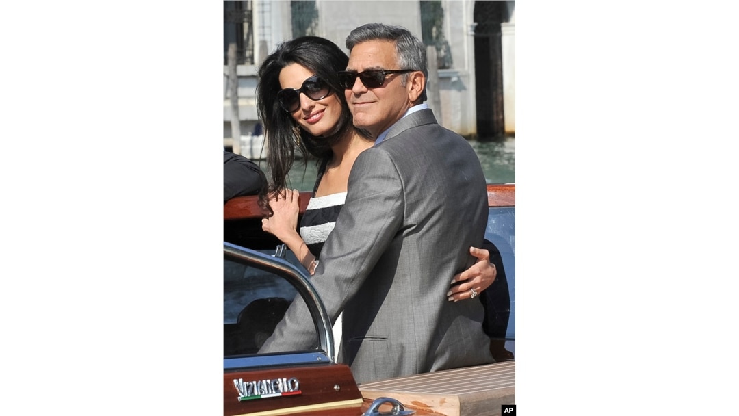 George Clooney and his fiancee Amal Alamuddin arrive in Venice, Italy, Sept. 26, 2014.