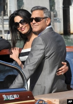 George Clooney and his fiancee Amal Alamuddin arrive in Venice, Italy, Sept. 26, 2014.