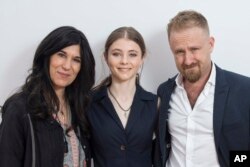 FILE -Director Debra Granik, left, poses with actors Thomasin McKenzie, center, and Ben Foster for the film "Leave No Trace," at the 71st international film festival, Cannes, southern France, May 14, 2018.