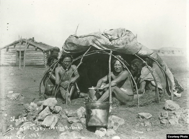 This 1898 photo by an unknown photographer shows a group of Dakota tribe members posing for the camera inside a sweat lodge. The raised coverings indicate that a sweat ceremony is not underway. Courtesy: National Archaeological Archives, Smithsonian Institution.