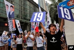 Supporters of Radical localist group Youngspiration's candidate Baggio Leung shout slogans near a polling station for the legislative council election, Sept. 4, 2016.