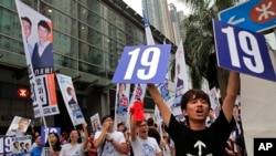 FILE - Supporters of Radical localist group Youngspiration's candidate Baggio Leung shout slogans near a polling station for the legislative council election, Sept. 4, 2016. 