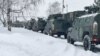 资料照片：俄罗斯国防部发布的照片显示在莫斯科郊外机场上等待运往哈萨克斯坦的俄军用车辆。（2022年1月6日）