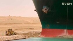 In this photo released by the Suez Canal Authority, a cargo ship, named the Ever Given, sits with its bow stuck into the wall Wednesday, March 24, 2021, after it become wedged across Egypt’s Suez Canal and blocked all traffic in the vital waterway.