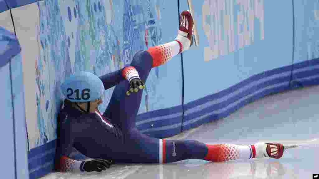 Sebastien Lepape of France crashes out in a men's 1000m short track speedskating heat at the Iceberg Skating Palace during the 2014 Winter Olympics, Feb. 13, 2014.