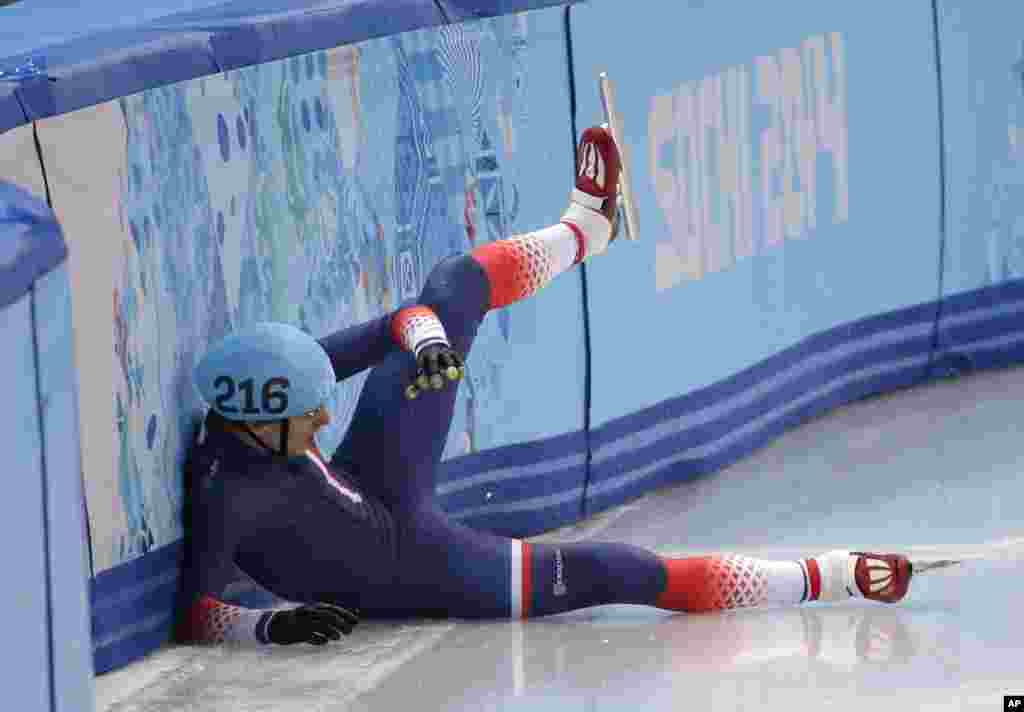 Sebastien Lepape of France crashes out in a men's 1000m short track speedskating heat at the Iceberg Skating Palace during the 2014 Winter Olympics, Feb. 13, 2014.