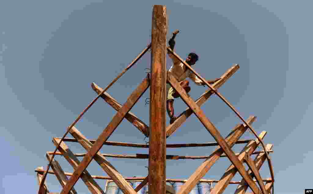 A carpenter carries out maintenance work on a boat at a construction yard for fishing vessels in Chennai, India.