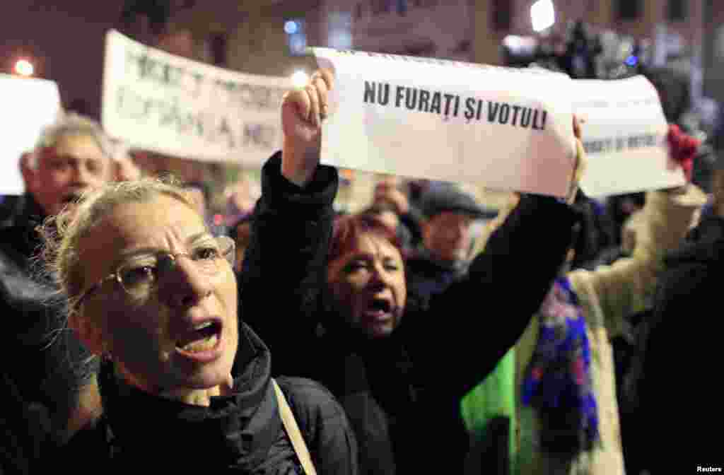 People shout slogans in support of compatriots living abroad who were turned away as they tried to vote in the first round of a presidential election, during a rally in Bucharest, Romania. Romania's leftist Prime Minister Victor Ponta is widely expected to win the presidential election in a Nov. 16 run-off vote against his opponent Klaus Iohannis.