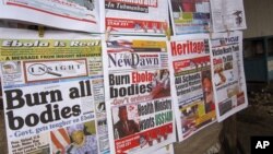 A close-up of newspaper front pages focusing on the Ebola outbreak, including a newspaper, reading 'Burn all bodies' in Monrovia, Liberia, July 31, 2014. 