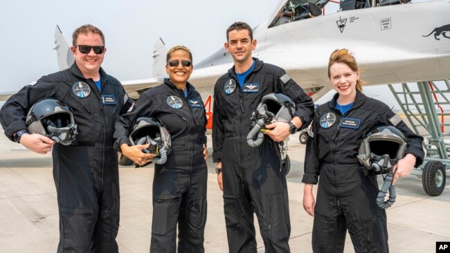 In this Aug. 8, 2021 photo provided by John Kraus, from left, Chris Sembroski, Sian Proctor, Jared Isaacman and Hayley Arceneaux stand for a photo in Bozeman, Mont., during a "fighter jet training" weekend. (John Kraus/Inspiration4 via AP)