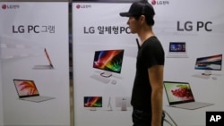 A man passes by banners advertising LG Electronics products at a shopping mall in Seoul, South Korea on July 27, 2016.