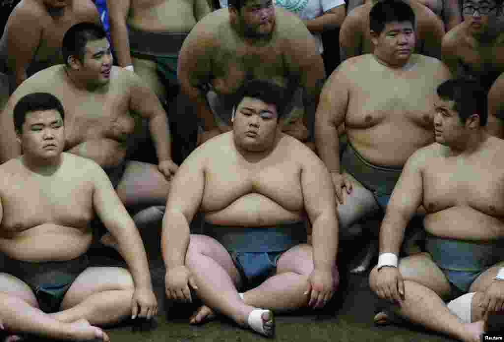 Traditional sumo wrestling club members at Saitama Sakae junior and senior high school prepare for a photo session with cyclists including Tour de France winner Christopher Froome of Britain in Saitama, north of Tokyo, Japan.