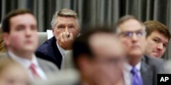 Mark Harris listens to the public evidentiary hearing on the 9th Congressional District investigation, Feb. 18, 2019, at the North Carolina State Bar in Raleigh, N.C.