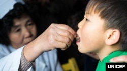 지난 2016년 북한 함경북도 수해지역에 마련된 임시진료소 직원이 유니세프가 지원한 백신과 비타민 보충제, 구충약을 어린이에게 투약하고 있다.