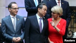 FILE - Australia's FM Julie Bishop talks to her Chinese counterpart, Wang Yi, as Germany's FM Heiko Maas watches, at the G20 Meeting of Foreign Affairs Ministers in Buenos Aires, Argentina, May 21, 2018. 