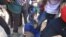 A police officer is assaulted by angry protesters in Harare, Monday, July, 4, 2016. (AP Photo/Tsvangirayi Mukwazhi)