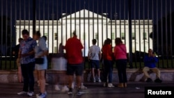 FILE - Tourists gather outside the White House in Washington on June 18, 2024. Reports say several top Democrats are urging U.S. President Joe Biden to quit his race for reelection.