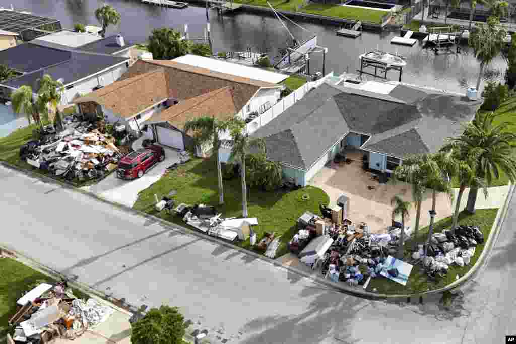 Debris from homes flooded in Hurricane Helene is piled curbside as Hurricane Milton approaches, in Port Richey, Florida.