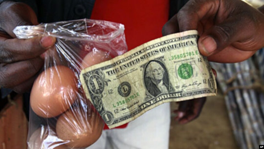 A man buys eggs using a U.S. one dollar bill at a market in Harare (File)