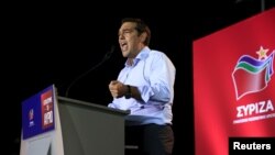 FILE - Former Greek Prime Minister and leader of leftist Syriza party Alexis Tsipras delivers a speech during a pre-election rally in the western suburb of Egaleo, in Athens, Sept. 3, 2015.