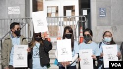 A group of Thai demonstrator holds the portraits of late Vicha Ratanapakdee, during a rally to raise awareness of anti-Asian violence outside the Hall of Justice, SF, March 4, 2021