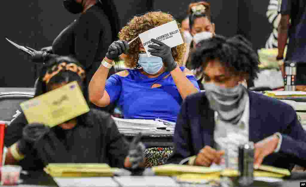 Election officials sort absentee ballots in Atlanta. Voters in Georgia return to the polls for runoffs to settle party nominations in four congressional races and 17 legislative races, as well as district attorney position, in Fulton County.