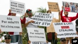 Drivers for ride-hailing giants Uber and Lyft rally near Los Angeles International Airport, May, 8, 2019, in Los Angeles. Some drivers for ride-hailing giants Uber and Lyft turned off their apps to protest what they say are declining wages as the companies rake in billions.