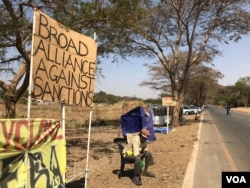 Members of a pro-Zimbabwe government group called Broad Coalition Against Sanctions have been camped outside the U.S. Embassy in Harare, demanding the sanctions be lifted, Aug. 20, 2019. They say sanctions hurt ordinary citizens. (C. Mavhunga/VOA)