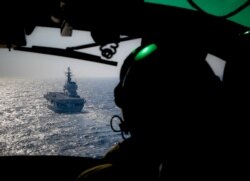 FILE - Italian Navy light aircraft carrier Giuseppe Garibaldi, seen from a helicopter, sails the Mediterranean Sea, off the coast of Sicily, part of the European Union's naval mission Operation Sophia, Nov. 25, 2016.