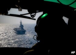 FILE - Italian Navy light aircraft carrier Giuseppe Garibaldi, seen from a helicopter, sails the Mediterranean Sea, off the coast of Sicily, part of the European Union's naval mission Operation Sophia, Nov. 25, 2016.