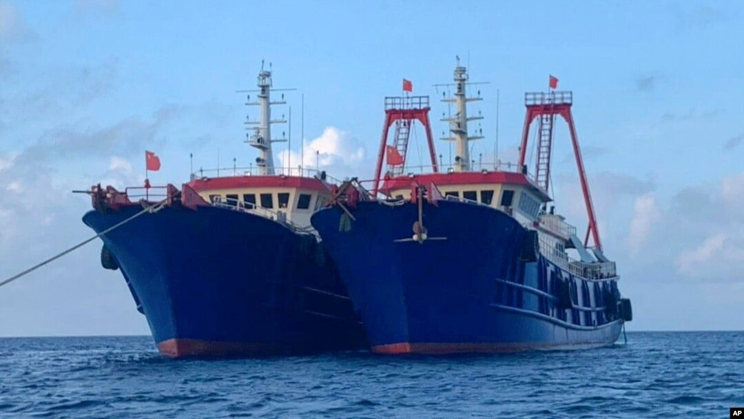 In this photo provided by the National Task Force-West Philippine Sea, Chinese vessels are moored at Whitsun Reef, South China Sea on March 27, 2021. 