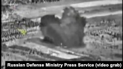 An image taken from footage made available on the Russian Defense Ministry's official website purports to show an explosion after airstrikes carried out by the Russian air force, Oct. 3, 2015.
