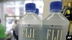 Bottles of Fiji water rest on a shelf at Corky's 12th Street Market, in Cleveland. The US-owned company has agreed to a massive tax hike imposed by the military government of Fiji (FILE).