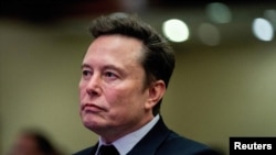 FILE - Tesla CEO and X owner Elon Musk listens as US President-elect Donald Trump speaks during a meeting with House Republicans at the Hyatt Regency hotel in Washington, on November 13, 2024. 