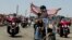 FILE - Participants in the annual Rolling Thunder motorcycle rally ride past Arlington Memorial Bridge during the parade ahead of Memorial Day in Washington, May 24, 2015.