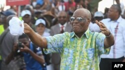 FILE - Albert Ondo Ossa, the leader of Gabon's main opposition coalition Alternance 2023, dances during a campaign meeting in Libreville on August 20, 2023.