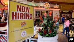 FILE - a restaurant posts a sign indicating they are hiring, in Miami. 