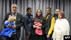 FILE - The families of missing British girls Amira Abase and Shamima Begum pose for a picture after being interviewed by the media in central London, Feb. 22, 2015. 