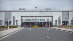 FILE - Police officers stand at the outer entrance of the Urumqi No. 3 Detention Center in Dabancheng in western China's Xinjiang Uyghur Autonomous Region, April 23, 2021.