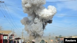 FILE - Smoke rises after suicide car bomb attack in Kunduz province, February 10, 2015.