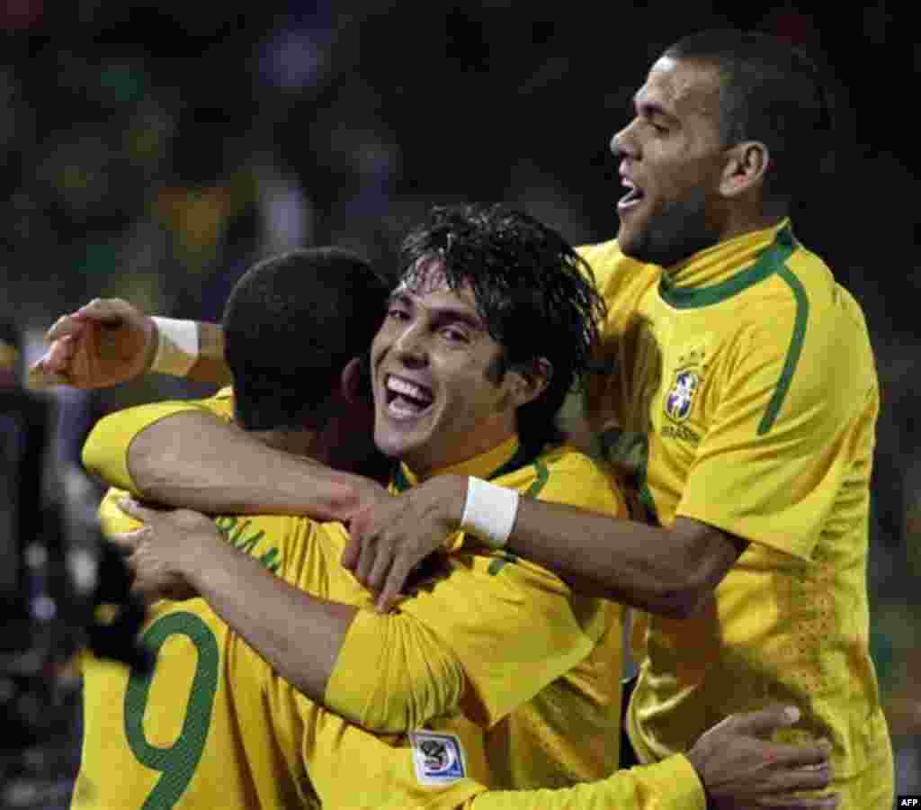 Brazil's Luis Fabiano, left, celebrates with Brazil's Kaka, center, and Brazil's Daniel Alves after scoring the second goal during the World Cup round of 16 soccer match between Brazil and Chile at Ellis Park Stadium in Johannesburg, South Africa, Monday,