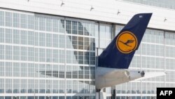 The tail of a Lufthansa airplane sticks out of a hangar at the Franz Josef Strauss airport in Munich, southern Germany.