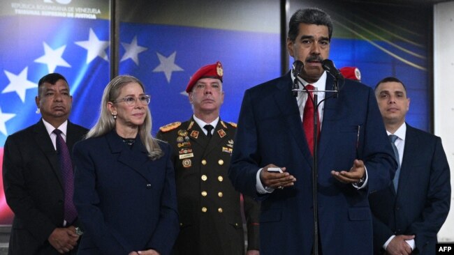 El presidente Nicolás Maduro declara a la prensa, acompañado de su esposa Cilia Flores, jefes militares y escoltas, en la sede del Tribunal Supremo de Justicia en Caracas, el 2 de agosto de 2024.