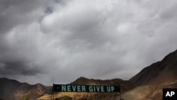 In this Sept. 14, 2017, file photo, a banner erected by the Indian army stands near Pangong Tso lake near the India-China border in India's Ladakh area.