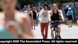 People go maskless on the Atlanta Beltline on Friday, May 14, 2021, after the CDC updated their mask guidelines for COVID-19 vaccinated people. 