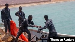 Somali Puntland forces receive weapons seized in a boat on the shores of the Gulf of Aden in the city of Bosasso, Puntland region, Somalia September 23, 2017.
