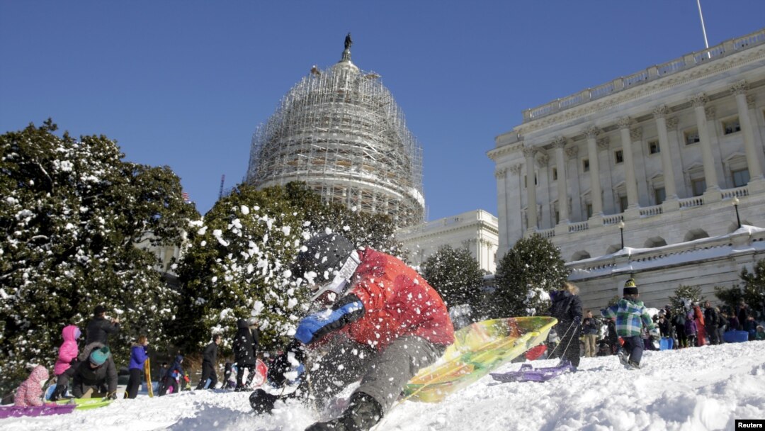 FILE - A boy crashes his sled on a hill at the U.S. Capitol after a major winter storm swept over Washington, Jan. 24, 2016.