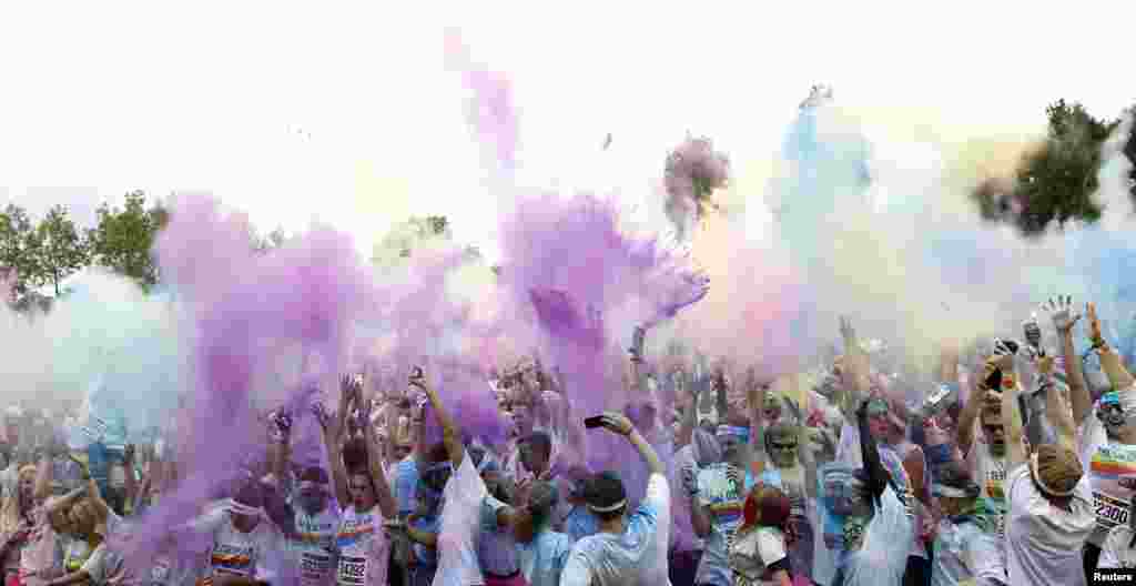 Runners cheer after they finished &#39;The Color Run&#39; in Munich, Germany. 